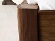 wooden bed with curved corners