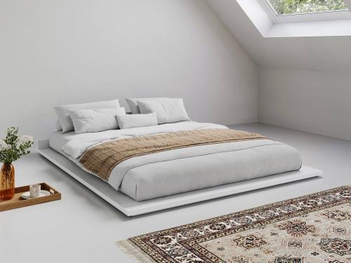 low wooden white attic bed