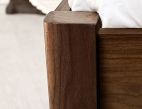 wooden bed with curved corners